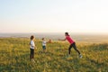 Mother and children playing with ball on meadow Royalty Free Stock Photo