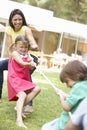 Mother And Children Playing Tug Of War Royalty Free Stock Photo