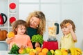 Mother and children are preparing the vegetables and fruit. Happy loving family. Healthy smoothie. Spinach smoothie Royalty Free Stock Photo