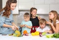 Mother with children preparing vegetables in the kitchen Royalty Free Stock Photo