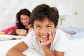 Mother And Children Relaxing In Bed Wearing Pajamas Royalty Free Stock Photo