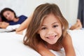 Mother And Children Relaxing In Bed Wearing Pajamas Royalty Free Stock Photo