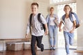 Mother And Children Returning Home After School Day