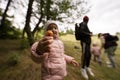 Mother and children searching mushrooms in the wild forest. Girl hold buttercup mushroom Royalty Free Stock Photo