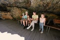 Mother with children sit on bench in Liechtensteinklamm or Liechtenstein Gorge, Austria