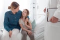 Mother with children sitting on the hospital bed Royalty Free Stock Photo