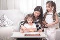 Mother with children sitting at the table and doing homework. The child learns at home. Home schooling Royalty Free Stock Photo