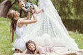 Mother and children are sitting in a tent teepee