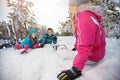 Mother with children on skiing resting on snow Royalty Free Stock Photo