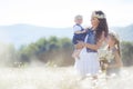 Mother with children in a summer field of blooming daisies Royalty Free Stock Photo