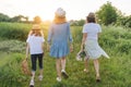 Mother with children two daughters walking along a country road, back view Royalty Free Stock Photo