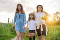 Mother with children two daughters walking along a country road Royalty Free Stock Photo