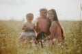 Mother and children two little daughters having fun in a meadow. Summer, nature, family, vacation. mother`s, baby`s day Royalty Free Stock Photo
