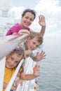 Mother with childrens stand on deck of ship