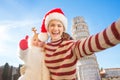 Mother in Christmas hat taking selfie with daughter in Pisa Royalty Free Stock Photo