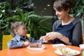 Mother cleans her son hand