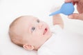 Mother cleans nose of a newborn baby whith a clyster Royalty Free Stock Photo