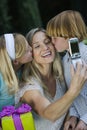 Mother Clicking Self Photo While Kids Kissing