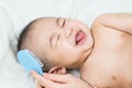 Mother is combing baby`s hair with hairbrush after bathing.selective focus Royalty Free Stock Photo
