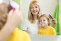 Mother is combing child hair after bathing Royalty Free Stock Photo