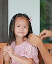 Mother is combing daughter`s hair after bathing Royalty Free Stock Photo