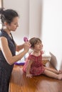 Mother combing the hair of her daughter