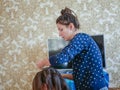 A mother is combing her baby. Mother caring for a child combing hair at home in the bedroom. maternal care Royalty Free Stock Photo