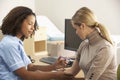 Mother comforting daughter having injection Royalty Free Stock Photo