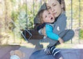 Mother comforting her crying little boy, mother and child portrait made through the window Royalty Free Stock Photo