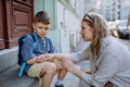 Mother consoling her little son on his first day of school,sitting on stair and saying goodbye before school. Royalty Free Stock Photo