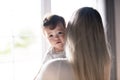 Mother consoling his child girl close to a window Royalty Free Stock Photo