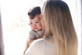 Mother consoling his child girl close to a window Royalty Free Stock Photo