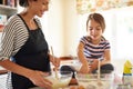 Mother, cooking or girl child baking in kitchen as a happy family with a young kid learning cookies recipe. Cake, baker Royalty Free Stock Photo