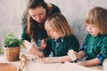 Mother cooking with kids in kitchen. Toddler siblings baking together and playing with pastry at home