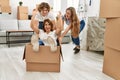 Mother and couple smiling confident transportating woman by cardboard box as a car at home Royalty Free Stock Photo