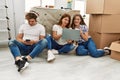 Mother and couple using smartphone and laptop sitting on the floor at home Royalty Free Stock Photo