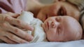 Mother cuddling with her newborn baby in their bed. Royalty Free Stock Photo