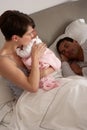 Mother Cuddling Newborn Baby In Bed Royalty Free Stock Photo