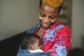 Mother with newborn in baby sling carrier at home Royalty Free Stock Photo