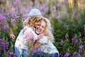 Mother and a cute little son hugging and having fun in the fild with flowers in summer. Family and happiness consept Royalty Free Stock Photo