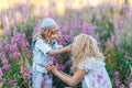 Mother and a cute little son hugging and having fun in the fild with flowers in summer. Family and happiness consept Royalty Free Stock Photo