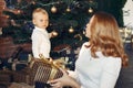 Mother with cute son at home near christmas tree Royalty Free Stock Photo