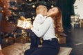 Mother with cute son at home near christmas tree Royalty Free Stock Photo