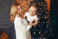 Mother with cute son at home near christmas tree Royalty Free Stock Photo