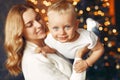 Mother with cute son at home near christmas tree Royalty Free Stock Photo