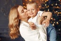 Mother with cute son at home near christmas tree Royalty Free Stock Photo