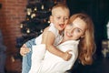 Mother with cute son at home near christmas tree Royalty Free Stock Photo