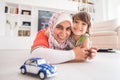 Mother and cute son playing with car toy