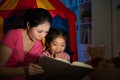 Mother and cute youth kid reading story toy book