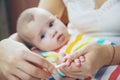 mother cuts little baby's nails. Selective focus.